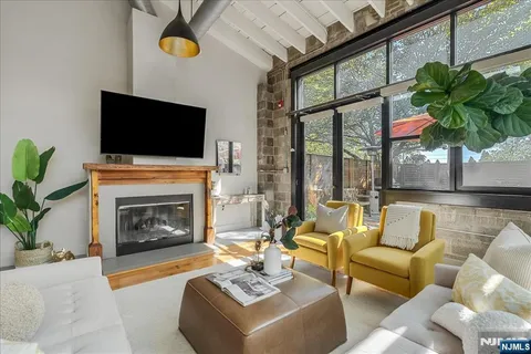 a living room with furniture a fireplace and a flat screen tv