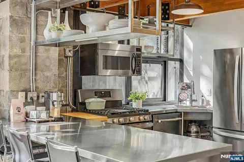 a kitchen with stainless steel appliances granite countertop a sink and cabinets