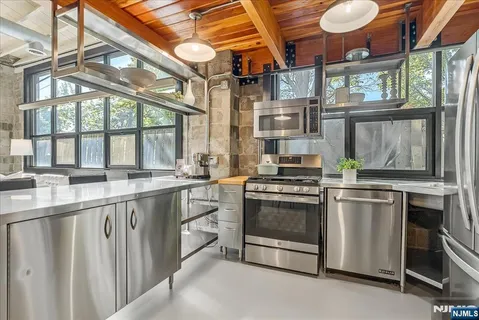 a kitchen with stainless steel appliances granite countertop a stove and a sink
