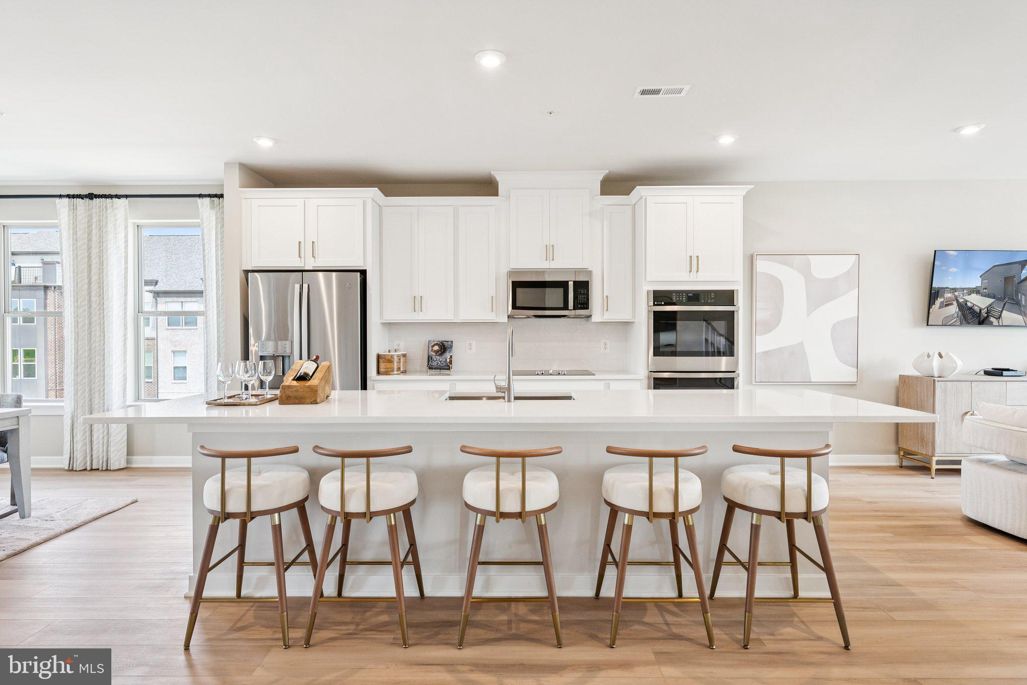 13717 Cobble Loop Woodbridge, VA 22193 - Photo 2 of 34 a kitchen with stainless steel appliances kitchen island granite countertop a stove a refrigerator a white table and chairs