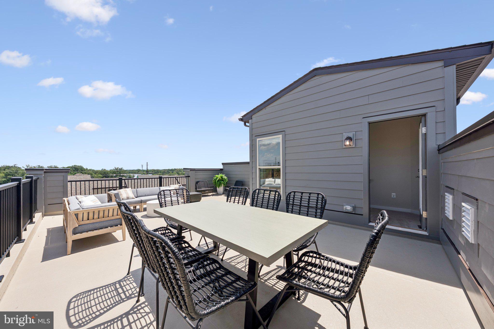 13717 Cobble Loop Woodbridge, VA 22193 - Photo 26 of 34 a view of a roof deck with table and chairs with wooden floor and fence