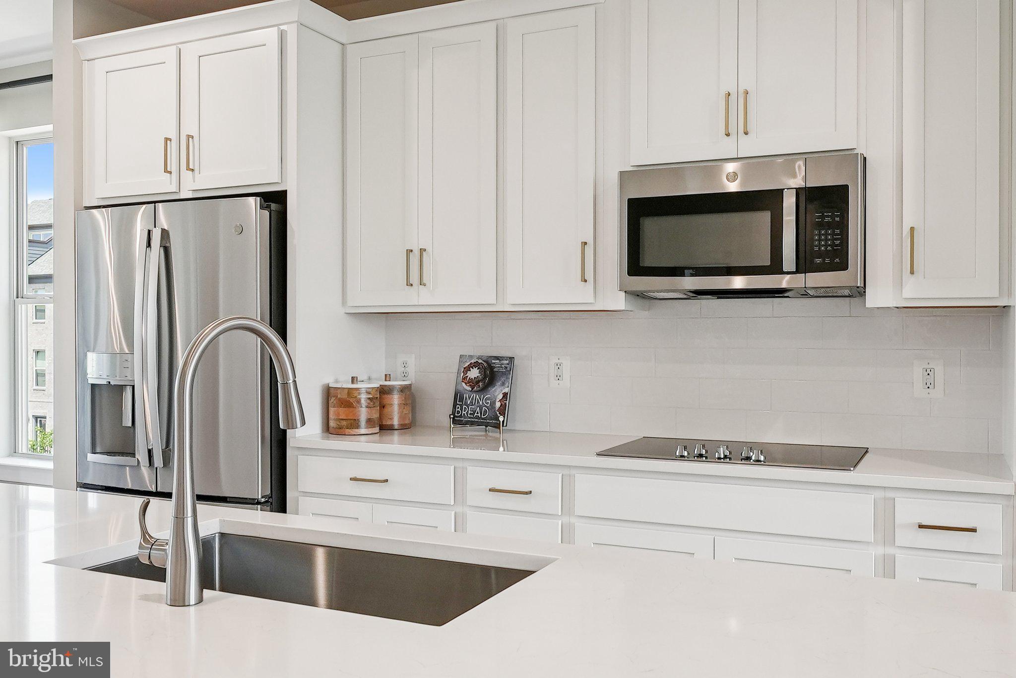 13717 Cobble Loop Woodbridge, VA 22193 - Photo 4 of 34 a kitchen with stainless steel appliances granite countertop white cabinets a sink and a microwave