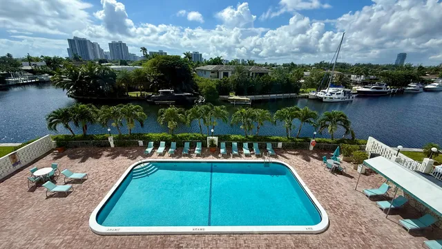 an aerial view of a house with a yard and lake view
