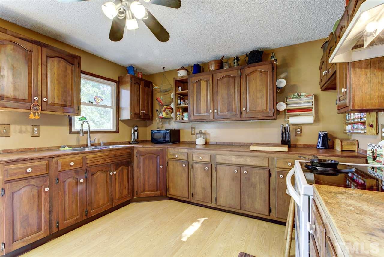 1481 Phillips Road Dunn, NC 28334 - Photo 13 of 30 a kitchen with stainless steel appliances granite countertop a sink and cabinets