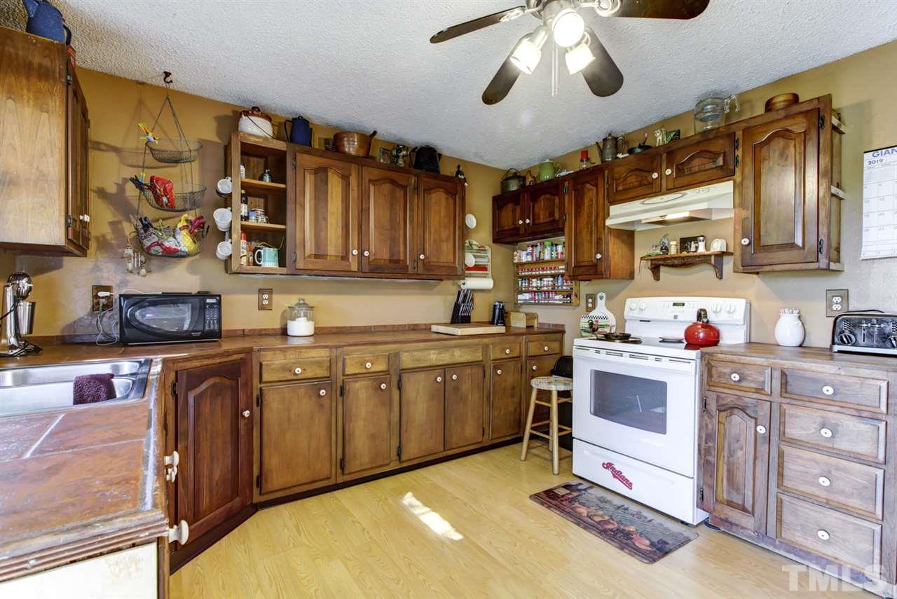 1481 Phillips Road Dunn, NC 28334 - Photo 14 of 30 a kitchen with stainless steel appliances granite countertop a sink and cabinets