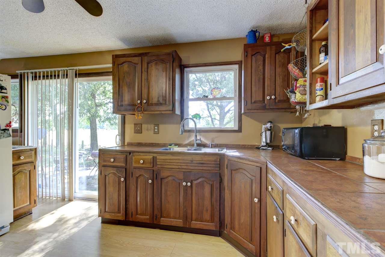 1481 Phillips Road Dunn, NC 28334 - Photo 16 of 30 a kitchen with stainless steel appliances granite countertop a sink stove and refrigerator