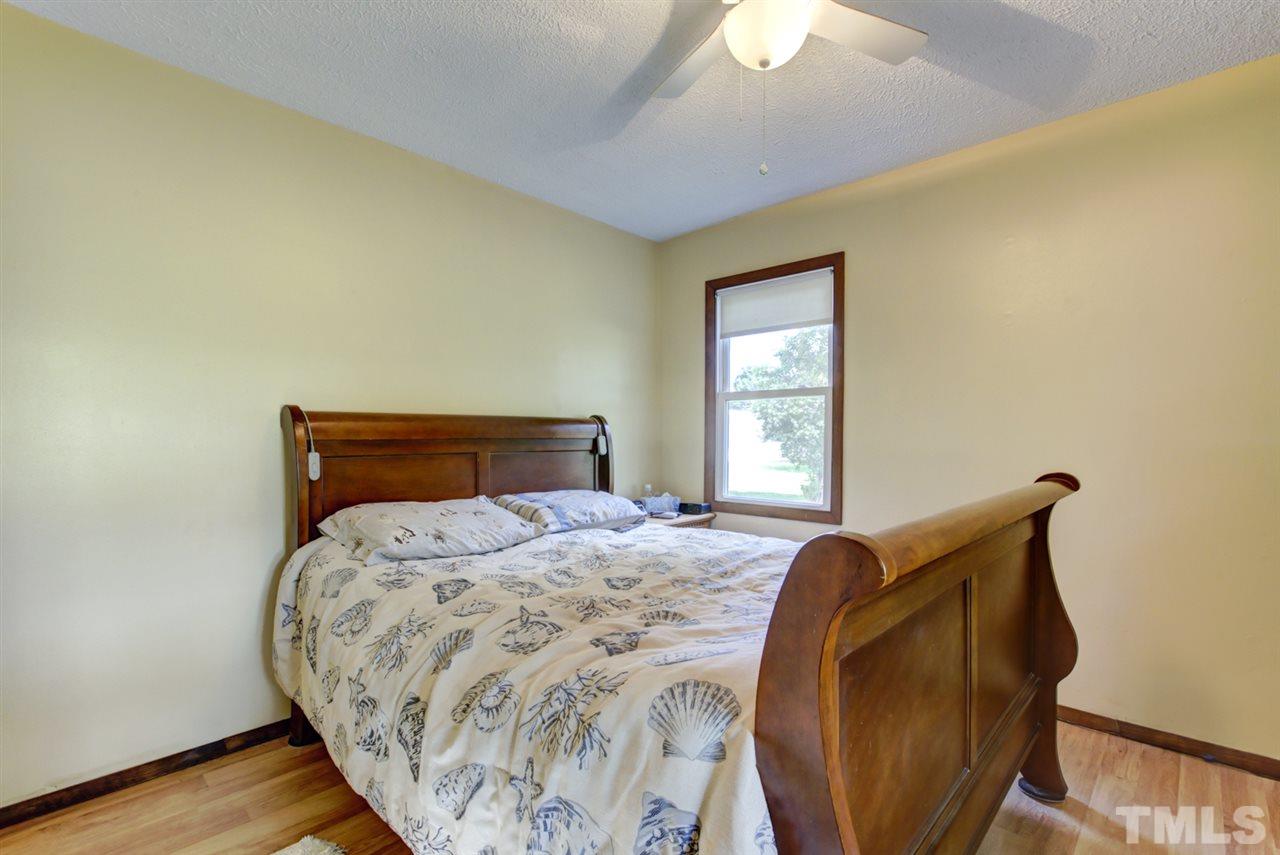 1481 Phillips Road Dunn, NC 28334 - Photo 18 of 30 a bedroom with bed and wooden floor