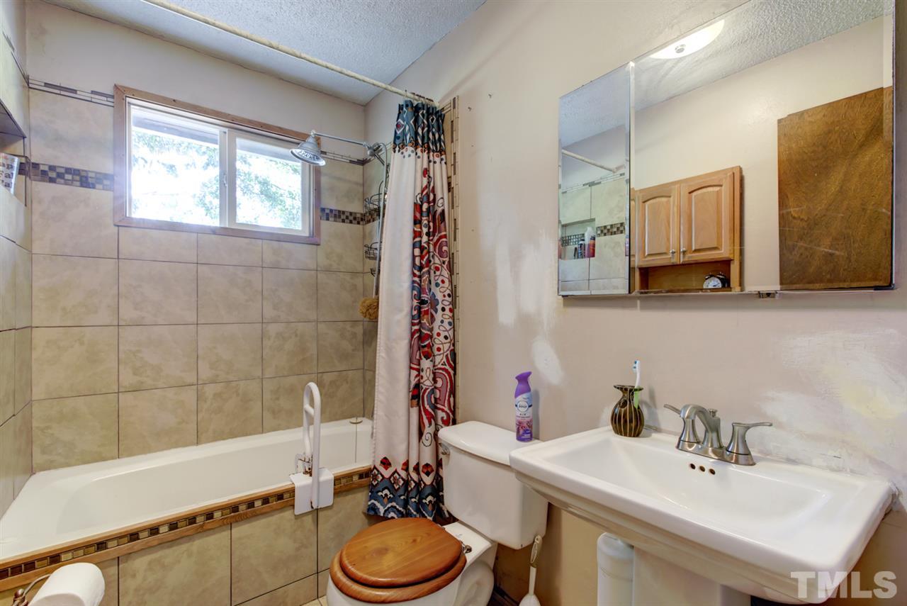1481 Phillips Road Dunn, NC 28334 - Photo 24 of 30 a bathroom with a sink a toilet and shower