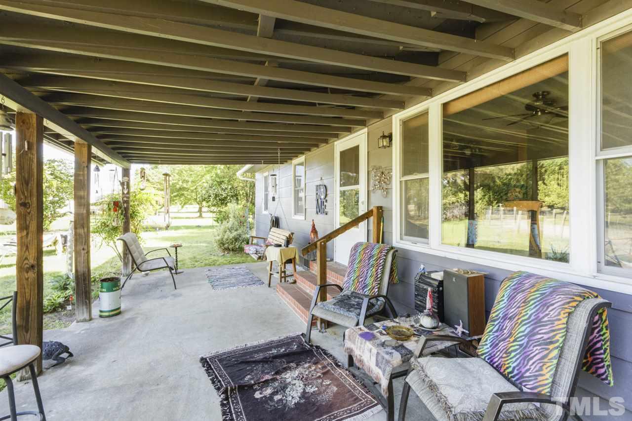 1481 Phillips Road Dunn, NC 28334 - Photo 6 of 30 a view of a porch with furniture and a yard