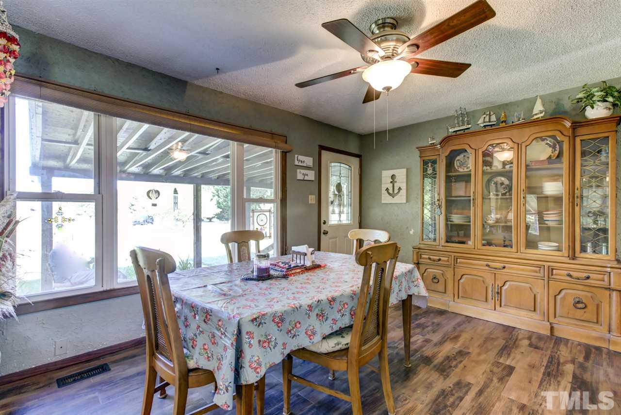 1481 Phillips Road Dunn, NC 28334 - Photo 8 of 30 a dining room with furniture a chandelier and wooden floor
