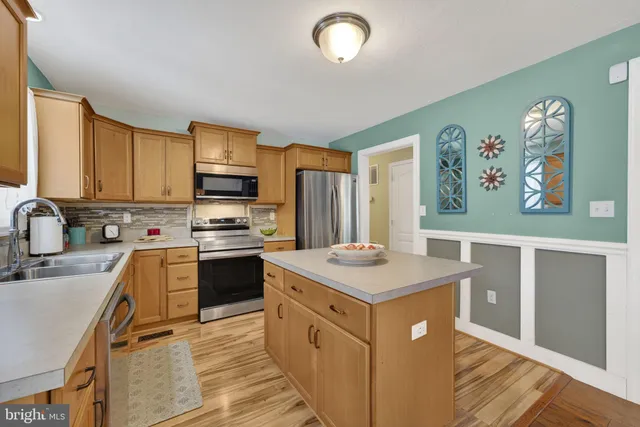 a spacious bedroom with a bed and a chandelier