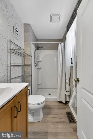 a view of a chair and tables in the balcony