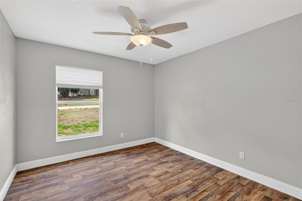 36 Bay Ridge Loop Mascotte, FL 34753 - Photo 23 of 32 wooden floor in an empty room with a window