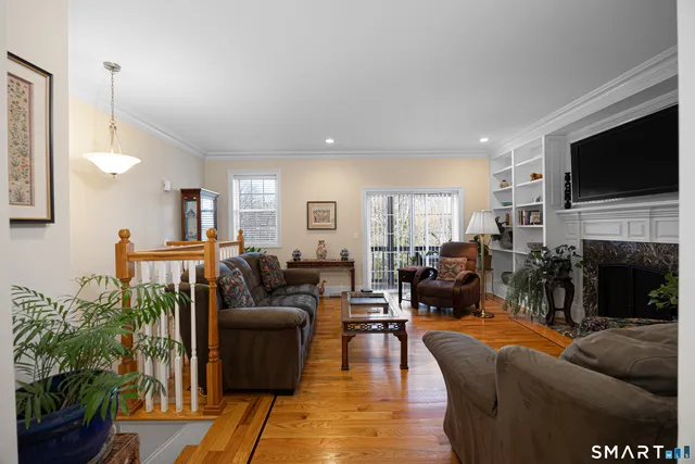 a living room with fireplace furniture and a flat screen tv