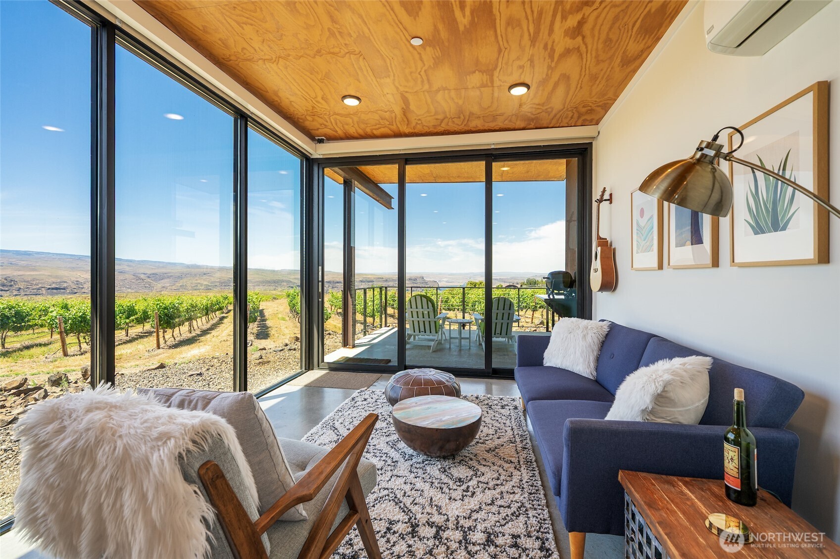 a living room with furniture and a floor to ceiling window