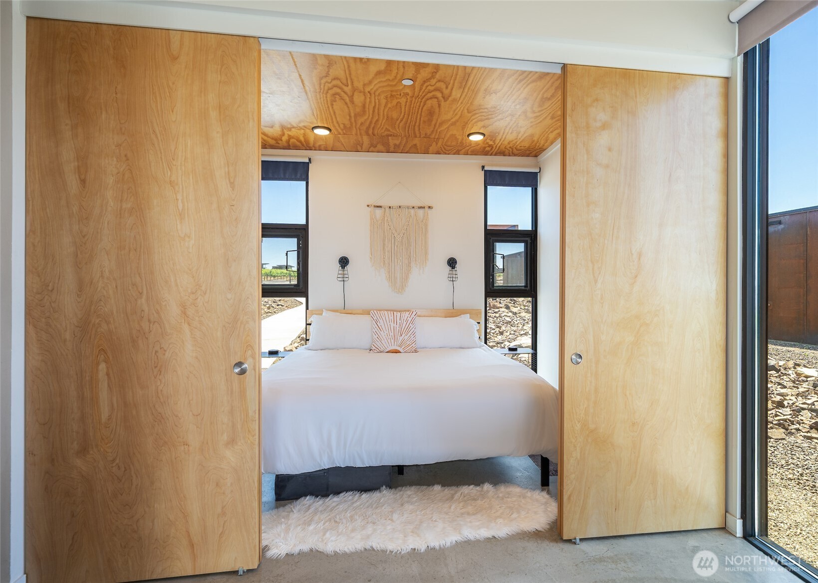 23648 Northwest Cliffe Pointe Road, Unit 10C Quincy, WA 98848 - Photo 13 of 26 a bedroom with a bed and a large mirror