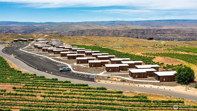 an aerial view of a house with a big yard