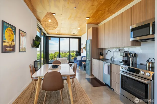 a kitchen with a table chairs stove and microwave