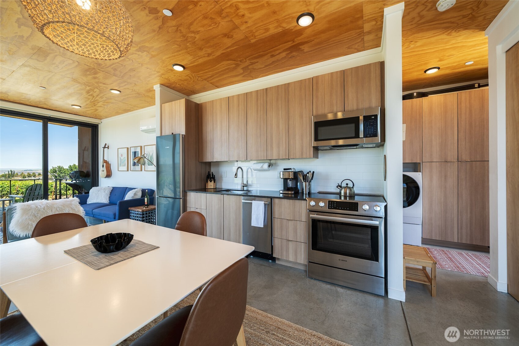 23648 Northwest Cliffe Pointe Road, Unit 10C Quincy, WA 98848 - Photo 9 of 26 a kitchen with stainless steel appliances a stove a sink a microwave a refrigerator and cabinets