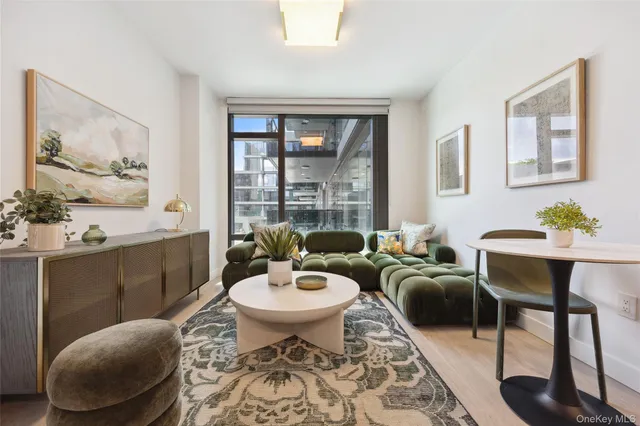 a living room with furniture a lamp and a potted plant