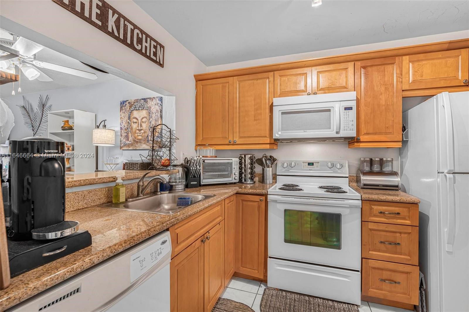 11249 Southwest 88th Street, Unit 203G Miami, FL 33173 - Photo 11 of 37 a kitchen with stainless steel appliances granite countertop a stove a sink dishwasher and refrigerator