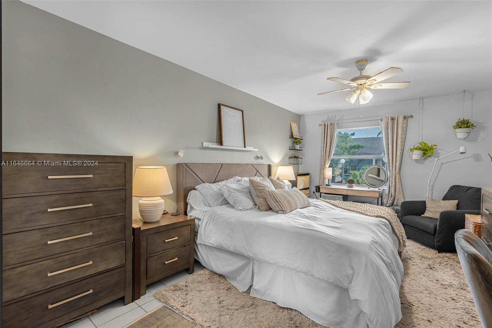 11249 Southwest 88th Street, Unit 203G Miami, FL 33173 - Photo 15 of 37 a bedroom with a bed and ceiling fan