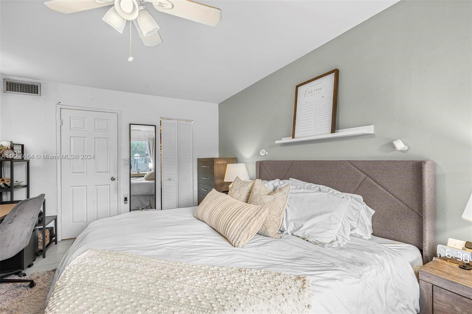 11249 Southwest 88th Street, Unit 203G Miami, FL 33173 - Photo 17 of 37 a bedroom with a bed and a chandelier