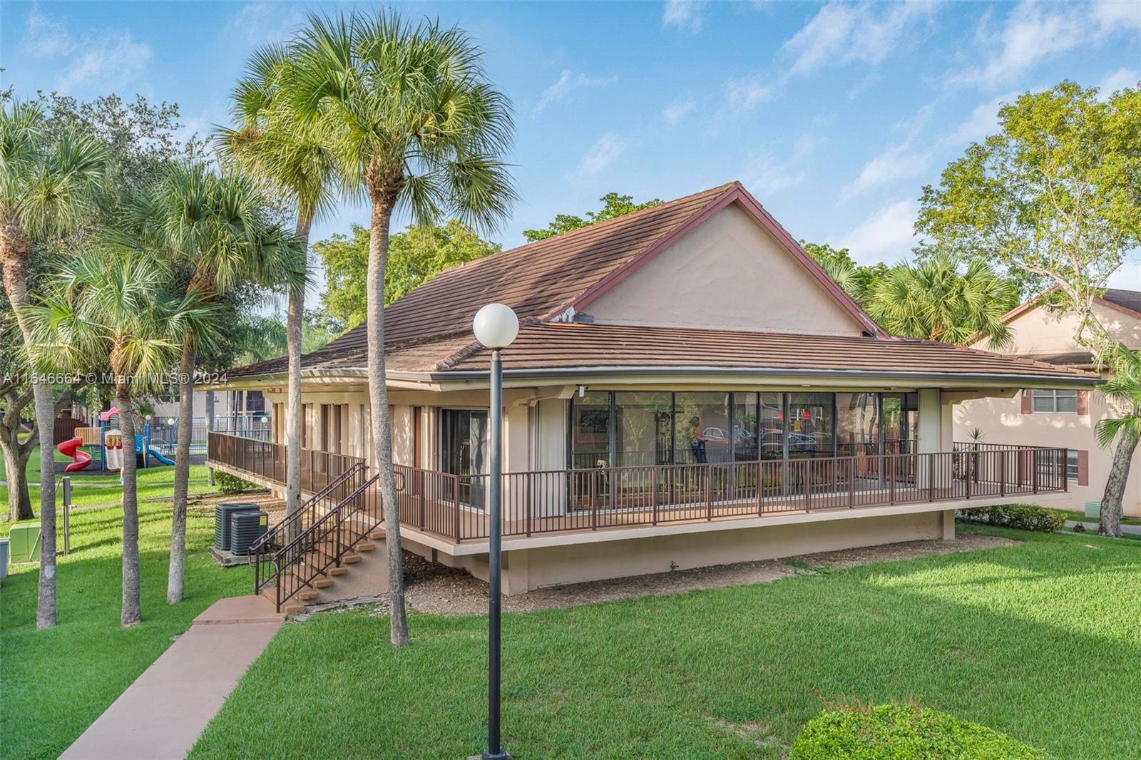 11249 Southwest 88th Street, Unit 203G Miami, FL 33173 - Photo 22 of 37 a front view of a house with a garden and yard