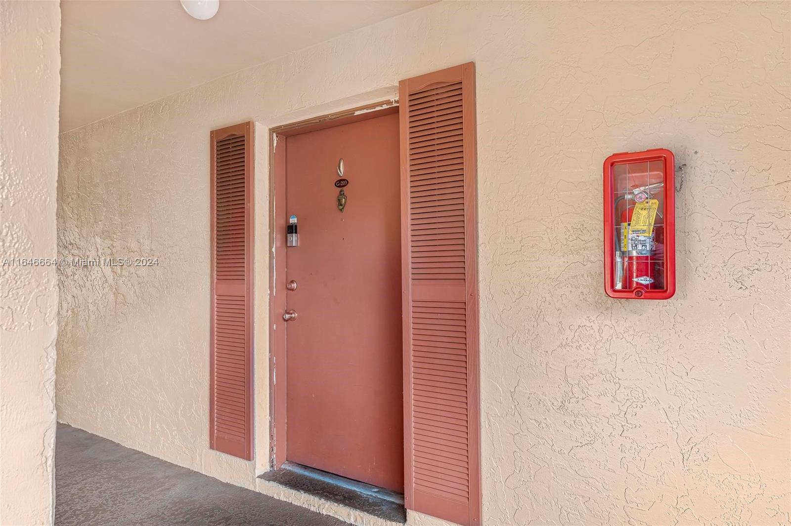 11249 Southwest 88th Street, Unit 203G Miami, FL 33173 - Photo 3 of 37 a view of a hallway with elevator