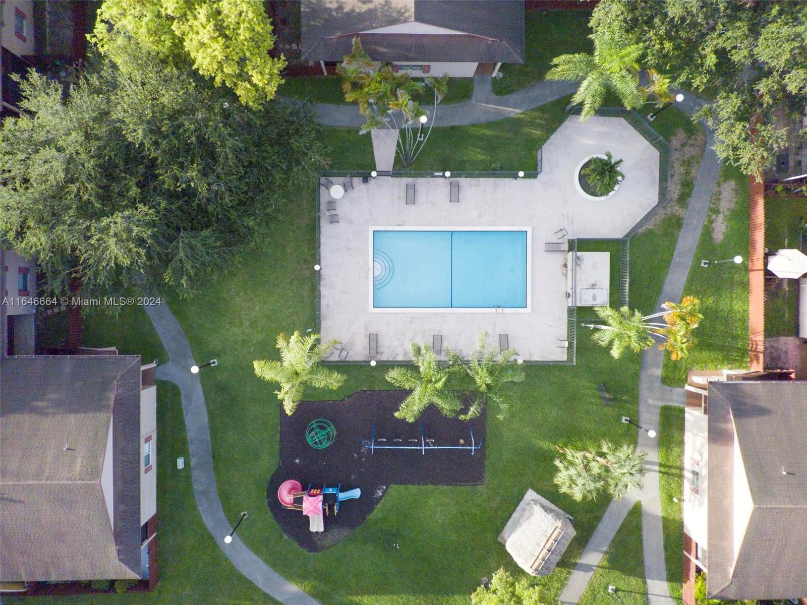 11249 Southwest 88th Street, Unit 203G Miami, FL 33173 - Photo 32 of 37 a view of a house with a backyard and a garden
