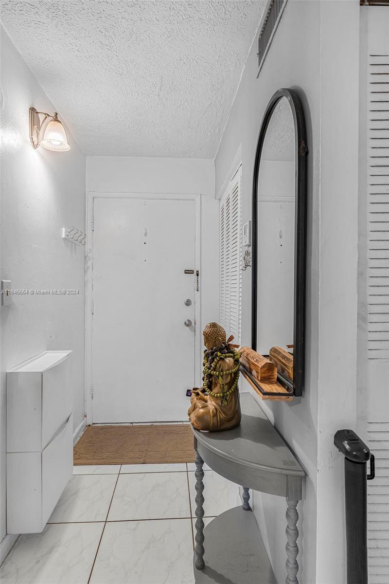 11249 Southwest 88th Street, Unit 203G Miami, FL 33173 - Photo 5 of 37 a room with a table and a mirror