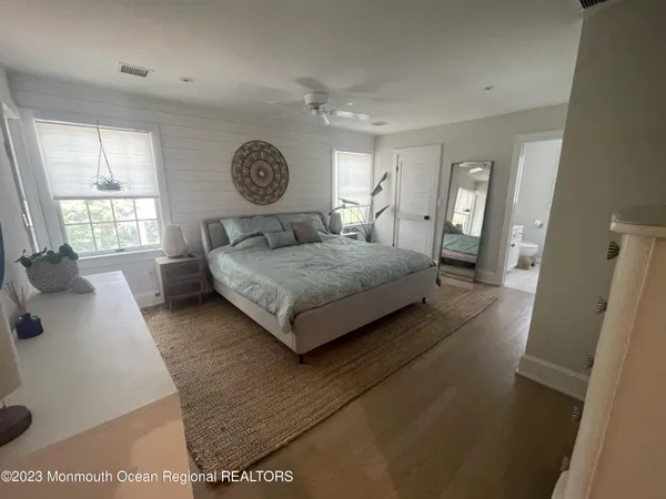 a living room with a bed furniture and a large window
