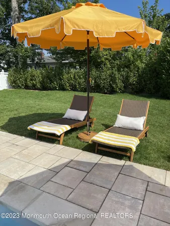 a view of a patio with a yard