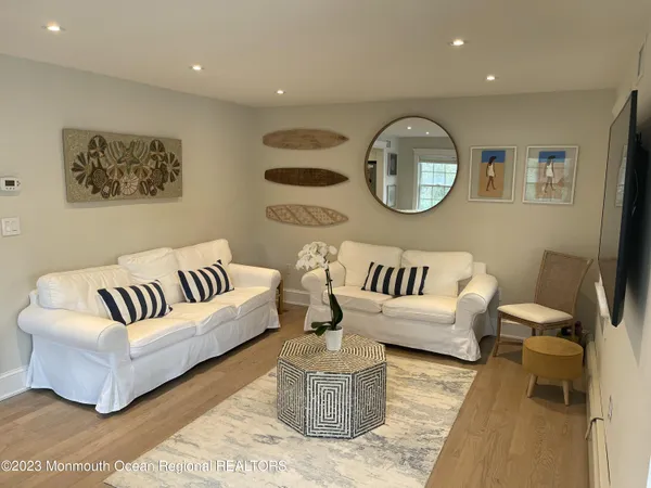 a living room with furniture and a mirror