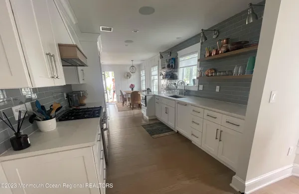 a kitchen with stainless steel appliances white cabinets and a sink