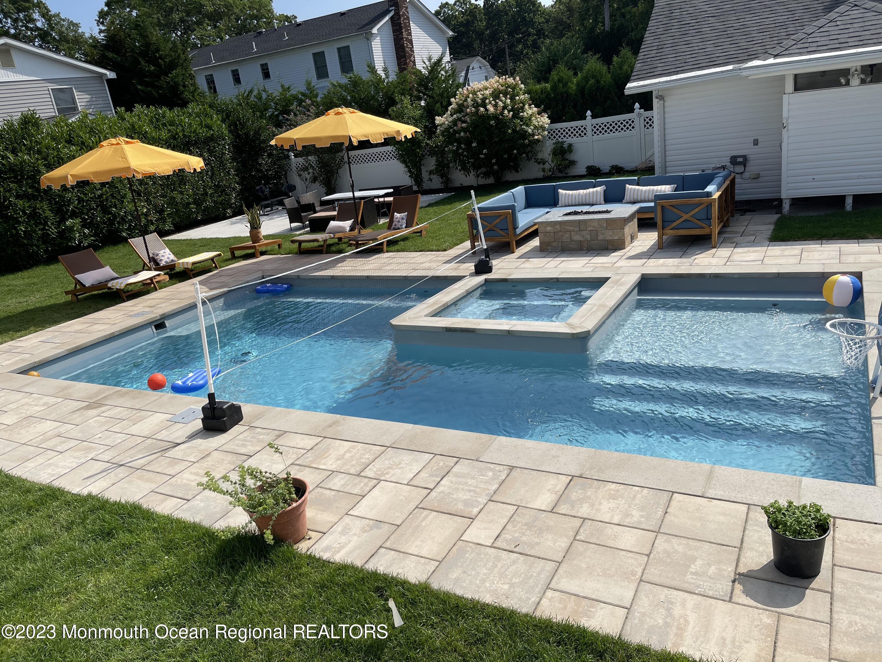 2112 Edgewood Place Spring Lake, NJ 07762 - Photo 9 of 24 a swimming pool with an outdoor seating and yard