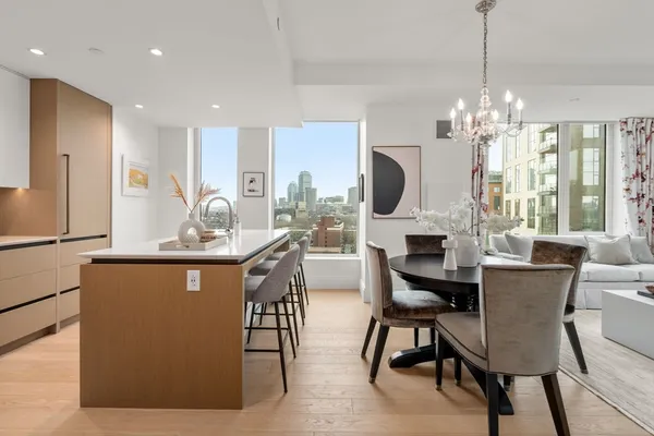a view of a dining room with furniture a chandelier and wooden floor
