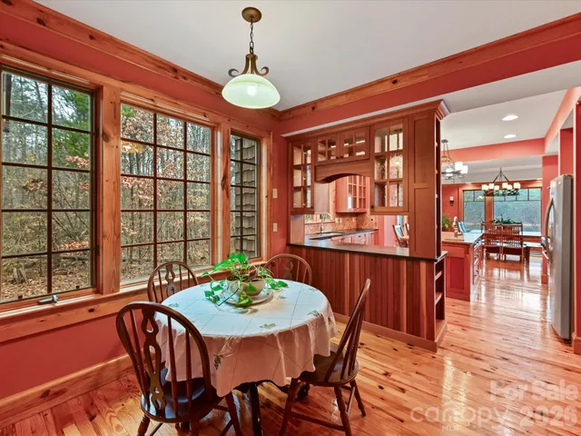 a view of a dining room with furniture large windows and wooden floor