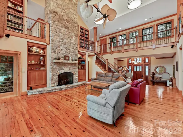 a living room with furniture a fireplace and a floor to ceiling window