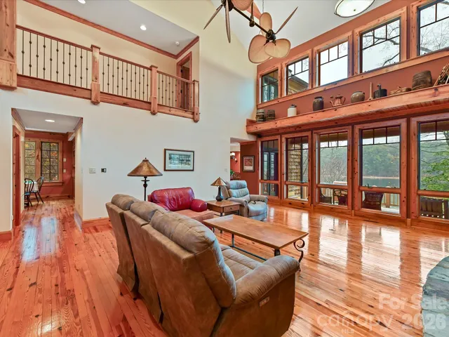 a living room with fireplace furniture and a large window