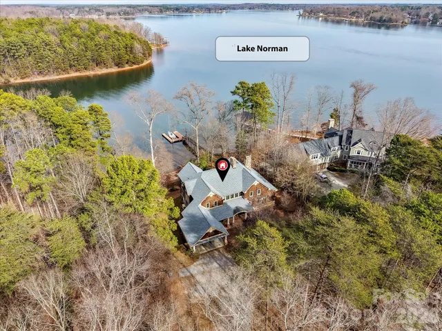 a backyard of a house with lots of green space and fountain