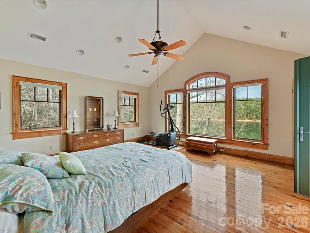 a bedroom with a large bed and a large window