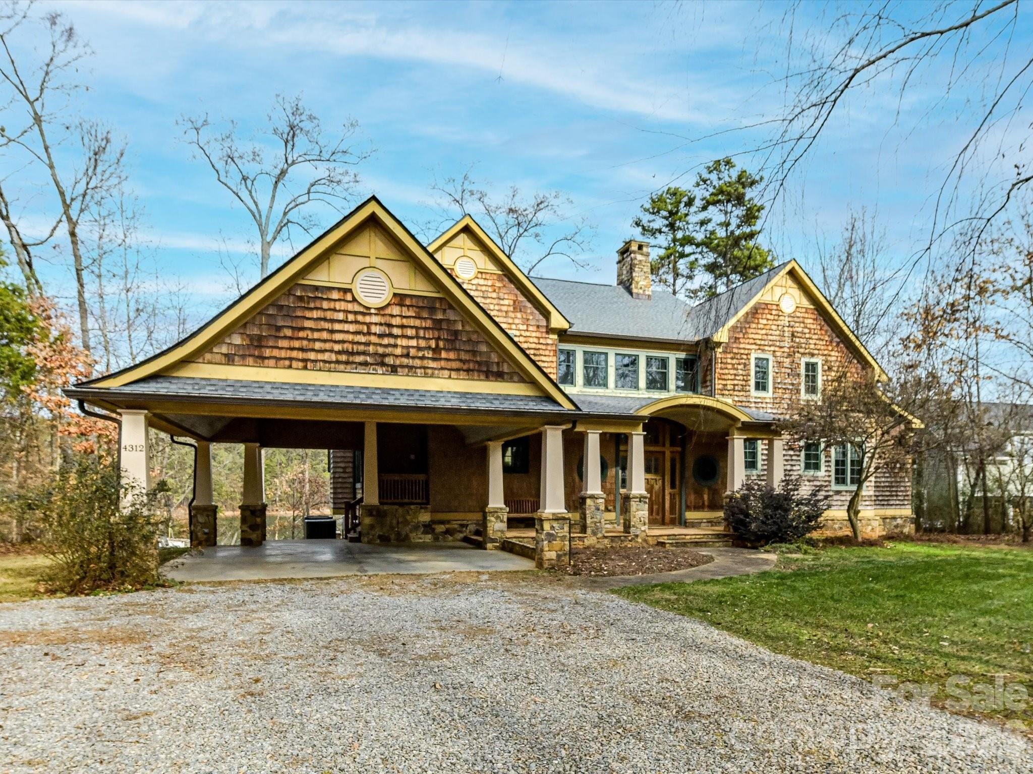 4312 Hazel Street Terrell, NC 28682 - Photo 4 of 45 a view of a white house with large windows and a table and chairs