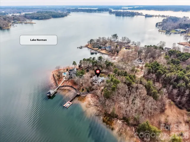 an aerial view of a backyard with table and chairs