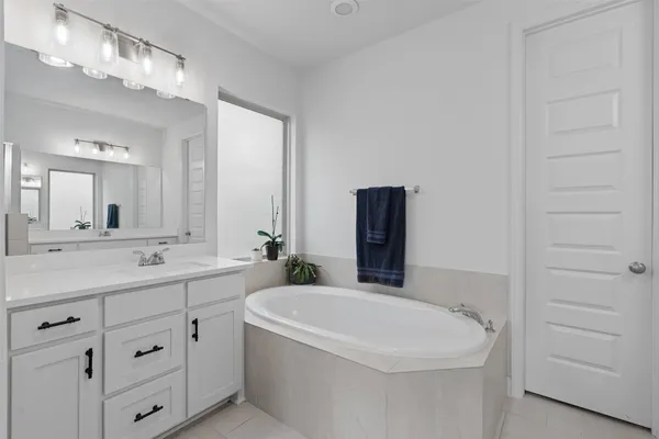 a bathroom with a double vanity sink and mirror