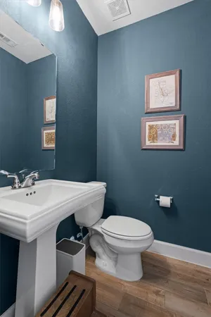 a bathroom with a sink a toilet and mirror