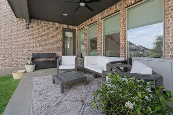 a view of a patio with table and chairs with a garden