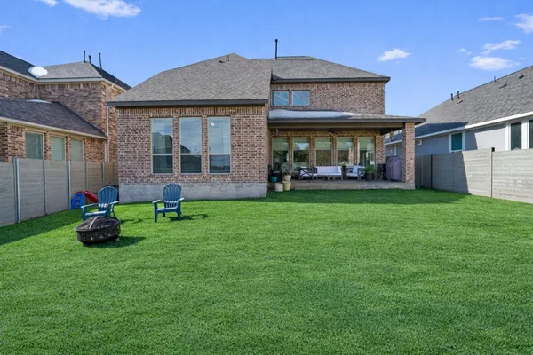 a view of a house with a yard and sitting area