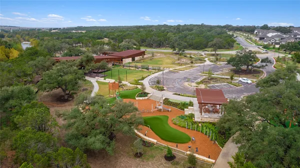an aerial view of residential houses with outdoor space and river