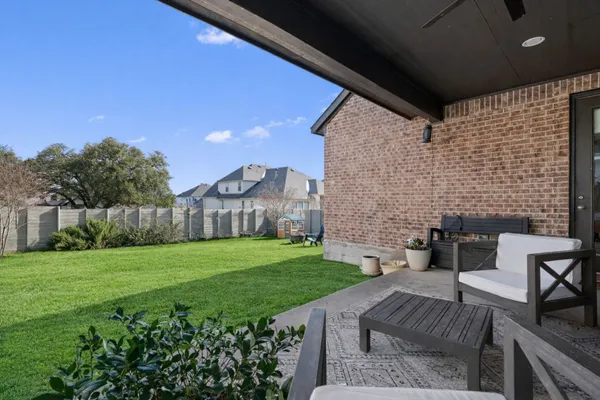 a view of yard with outdoor seating and barbeque oven